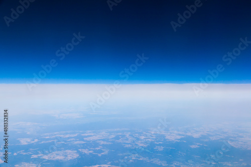 View from the plane at an altitude of 10 000 meters. Land from the height of a flying plane.