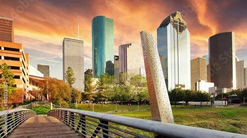 Time lapse at sunset in Houston, Texas, USA. Wooden bridge in Buffalo Bayou Park, with a beautiful view of downtown Houston (skyline / skyscrapers) in background on a summer day. photo