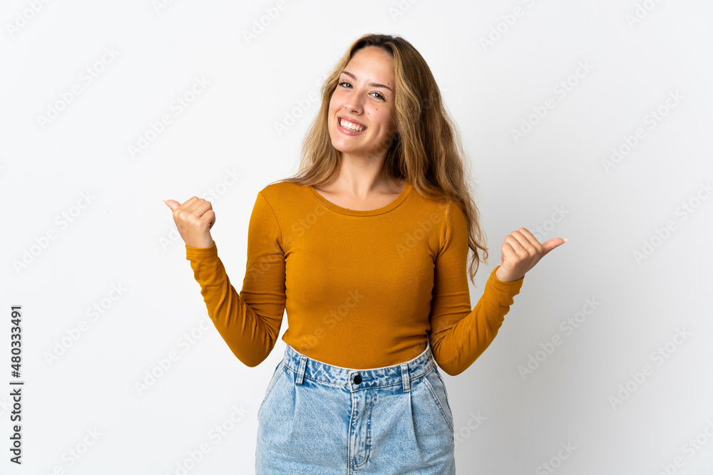 Young blonde woman isolated on blue background with thumbs up gesture and smiling Young blonde woman isolated on blue background with thumbs up gesture and smiling