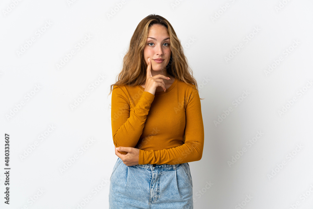 Young blonde woman isolated on blue background and thinking Young blonde woman isolated on blue background and thinking