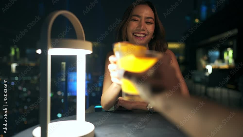 4K Two beautiful Asian woman friends meeting and dinner with cocktail drink together at skyscraper rooftop restaurant at night. Female friend enjoy outdoor lifestyle activity nightlife in the city. 4K Two beautiful Asian woman friends meeting and dinner with cocktail drink together at skyscraper rooftop restaurant at night. Female friend enjoy outdoor lifestyle activity nightlife in the city.