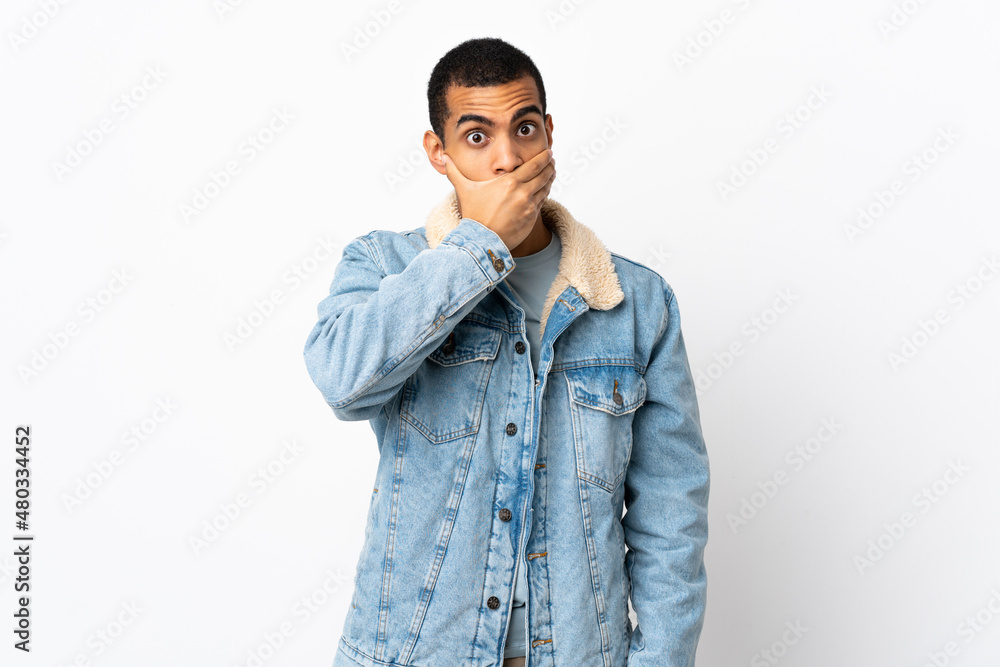 African American man over isolated white background covering mouth with hand African American man over isolated white background covering mouth with hand