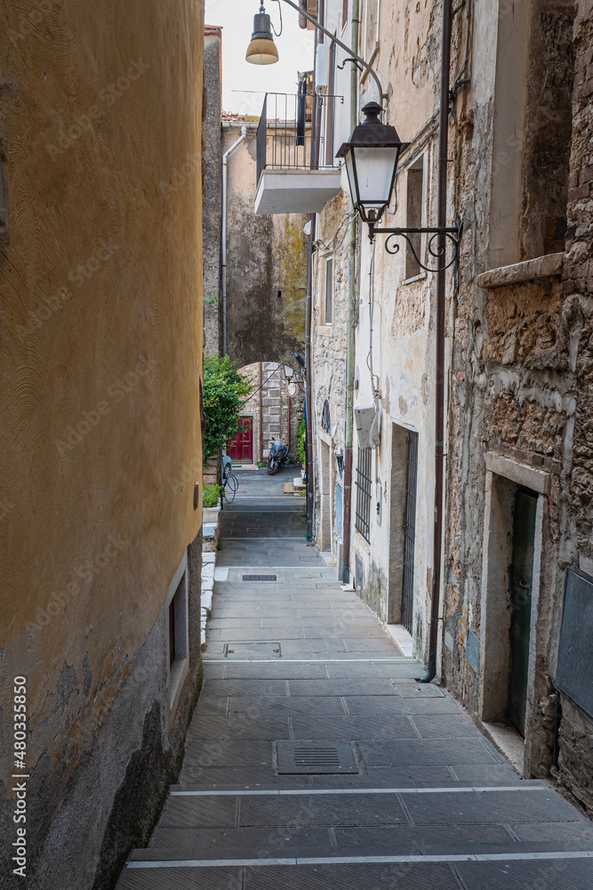 Narrow Street with Ancient Walls, antique Lamp Post in the Village of Colonnata, Carrara- Italy Narrow Street with Ancient Walls, antique Lamp Post in the Village of Colonnata, Carrara- Italy
