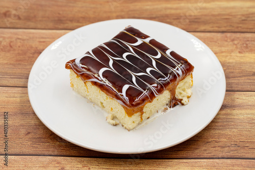 Caramel trilece dessert on wooden background. Traditional Turkish cuisine flavor. close up photo