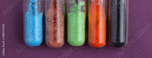 A set of colored salts - reagents: blue copper sulfate, brown cobalt sulfate, green nickel chloride, orange potassium dichromate, black potassium permanganate.