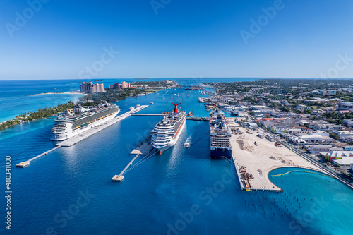 The drone aerial view of cruise ships in the clear blue Caribbean ocean docked in the port of Nassau, Bahamas.