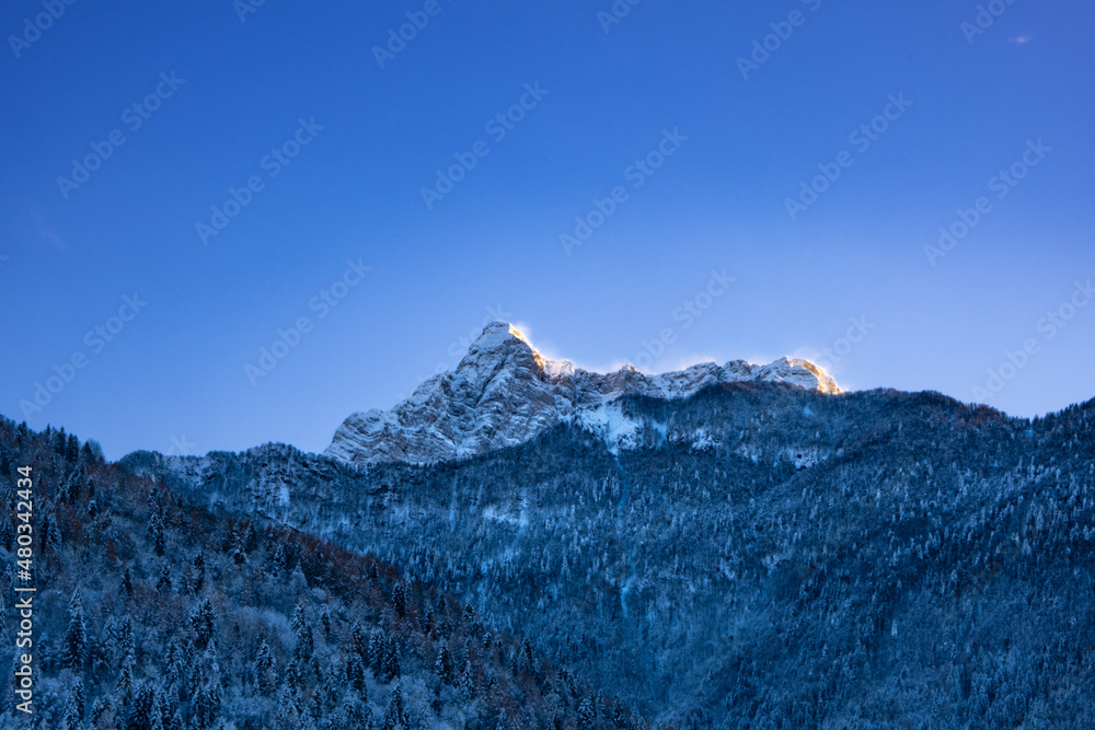 Snowy mountains and blue sky in winte