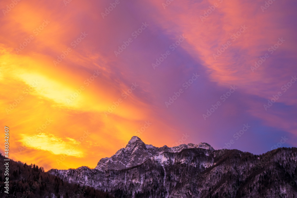 Pink purple and orange sunrise sky over mountain peaks
