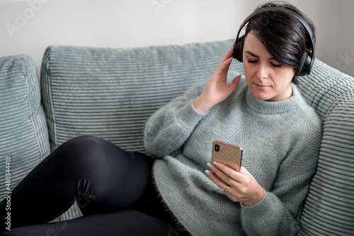 Young woman is resting on a sofa