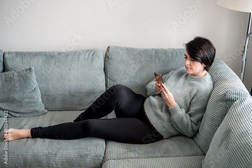 Young woman is resting on a sofa