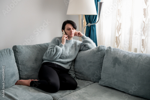 Young woman is resting on a sofa