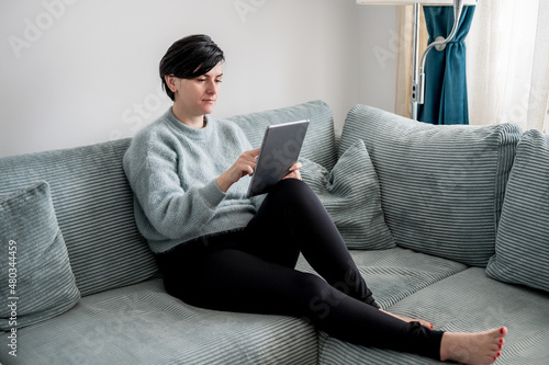 Young woman is resting on a sofa