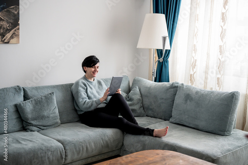 Young woman is resting on a sofa