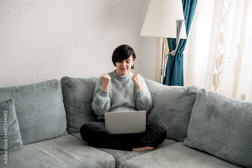 Young woman is resting on a sofa