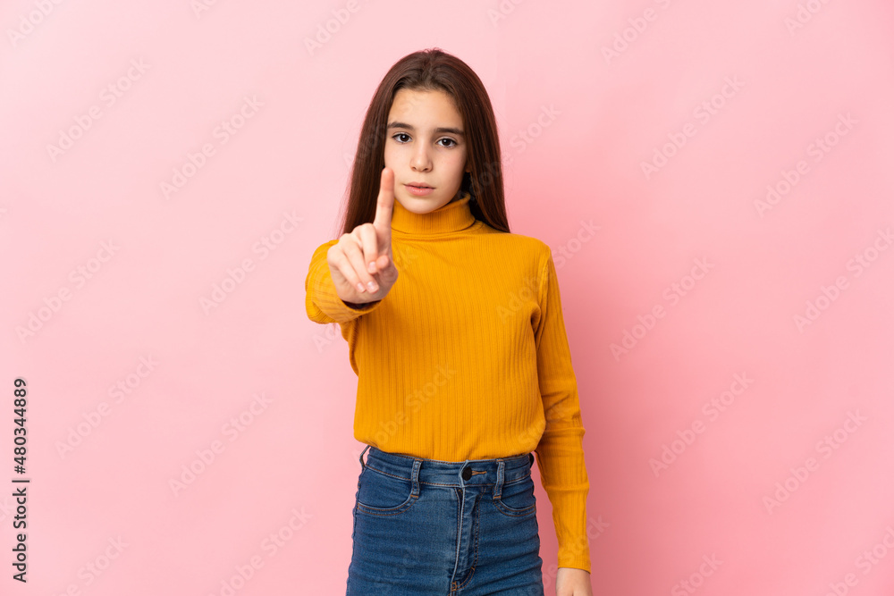 Little girl isolated on pink background counting one with serious expression Little girl isolated on pink background counting one with serious expression