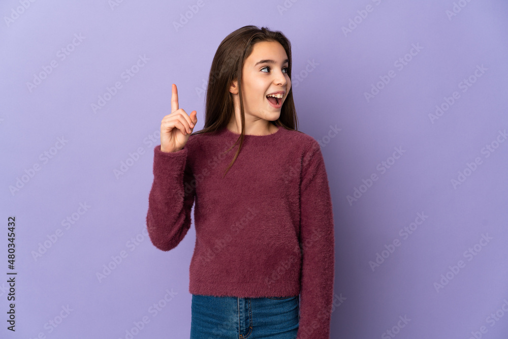 Little girl isolated on purple background intending to realizes the solution while lifting a finger up Little girl isolated on purple background intending to realizes the solution while lifting a finger up