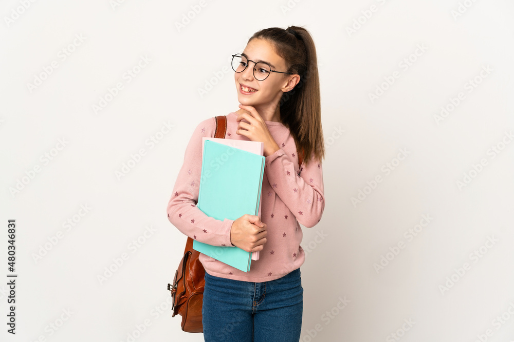 Little student girl over isolated background looking up while smiling Little student girl over isolated background looking up while smiling