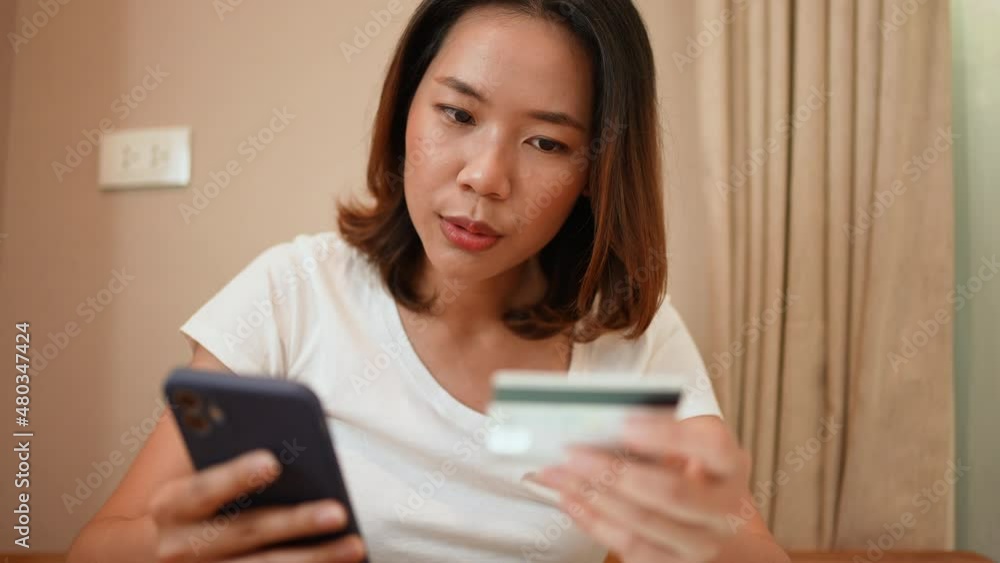 slow motion scene asian woman holding smartphone with credit card for pay online shopping e-commerce concept slow motion scene asian woman holding smartphone with credit card for pay online shopping e-commerce concept