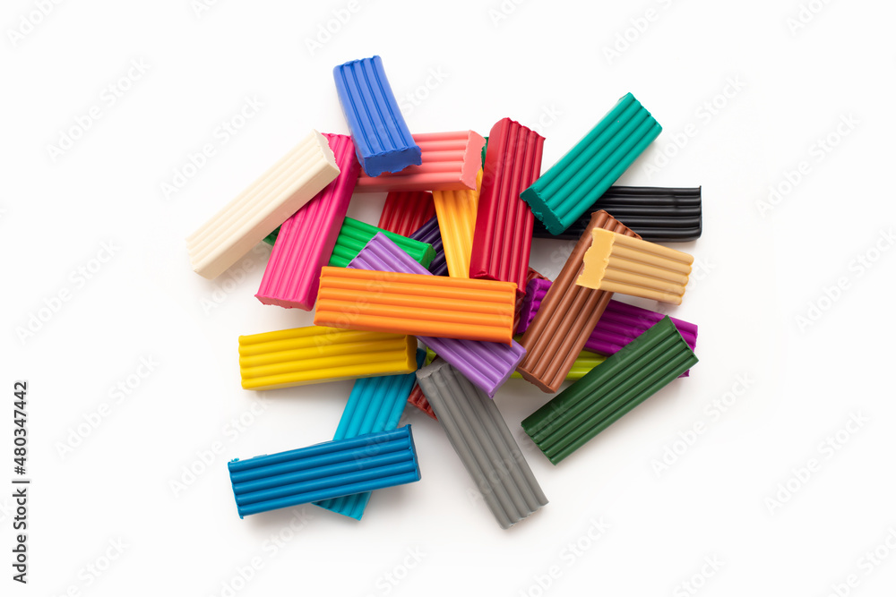 Colorful plasticine modeling clay sticks isolated on white background with clipping path. 24 colors set. Top view, closeup heap. Colorful plasticine modeling clay sticks isolated on white background with clipping path. 24 colors set. Top view, closeup heap.