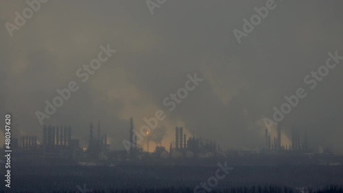 Factory chimneys pollute the air, environmental problems. It's snowing ash at sunset. Industrial pollution, exhaust fumes from the chimney. Industrial area, thick smoke. Climate change, ecology, atmos
