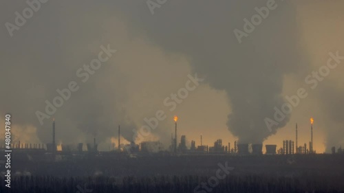 Factory chimneys pollute the air, environmental problems. It's snowing ash at sunset. Industrial pollution, exhaust fumes from the chimney. Industrial area, thick smoke. Climate change, ecology, atmos