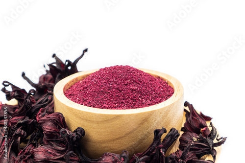 Powder of Roselle flower buds in wooden bowl and dried roselle isolated on white background