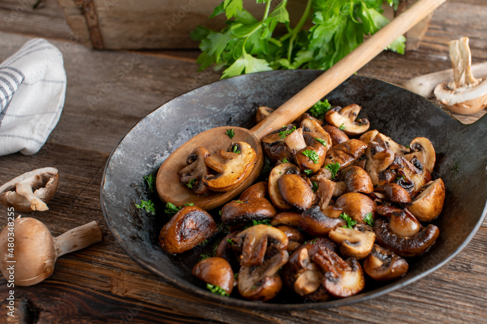 Fototapeta premium Pan fried mushrooms cooked with butter and herbs