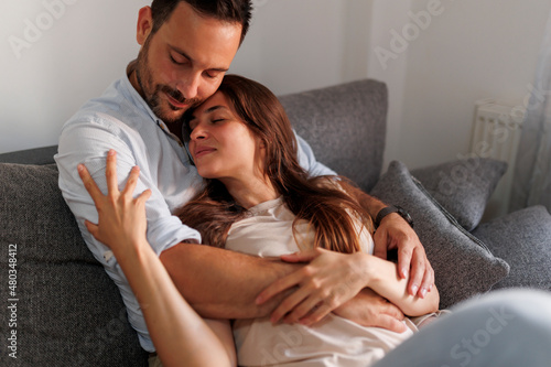 Couple relaxing and hugging at home