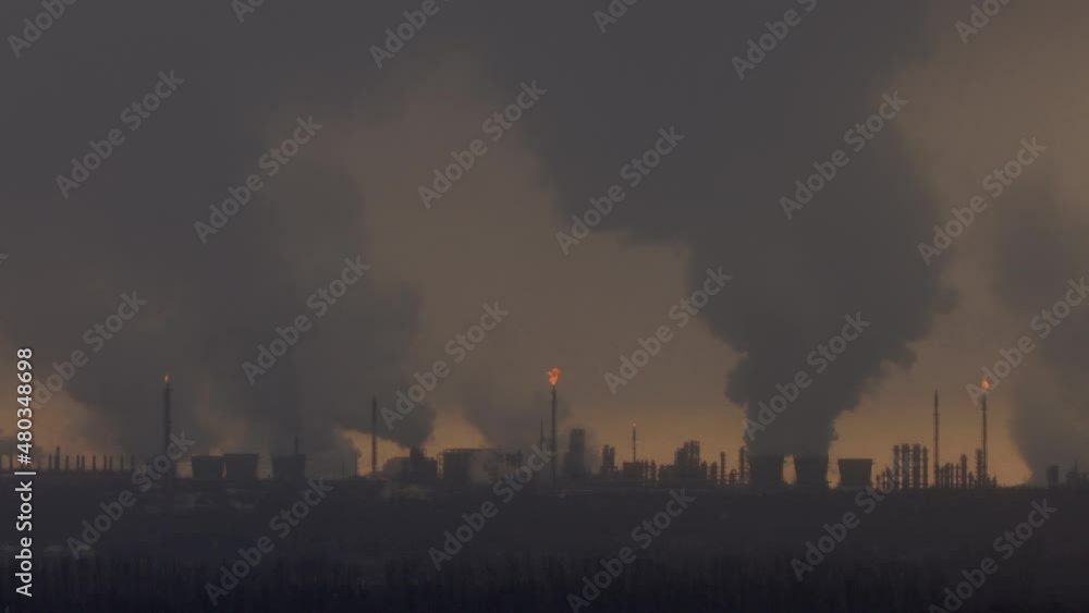 Factory chimneys pollute the air, environmental problems. It's snowing ash at sunset. Industrial pollution, exhaust fumes from the chimney. Industrial area, thick smoke. Climate change, ecology, atmos Factory chimneys pollute the air, environmental problems. It's snowing ash at sunset. Industrial pollution, exhaust fumes from the chimney. Industrial area, thick smoke. Climate change, ecology, atmos