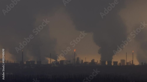 Factory chimneys pollute the air, environmental problems. It's snowing ash at sunset. Industrial pollution, exhaust fumes from the chimney. Industrial area, thick smoke. Climate change, ecology, atmos