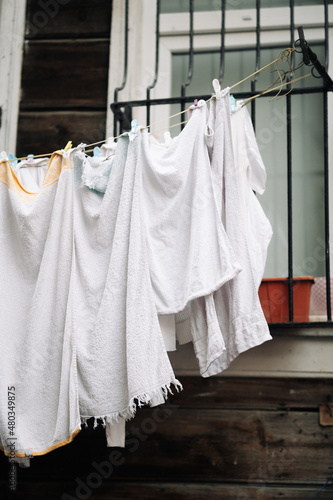White laundry after washing is hanging outside and drying