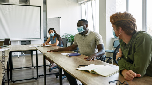 Employee telling to colleagues at company meeting