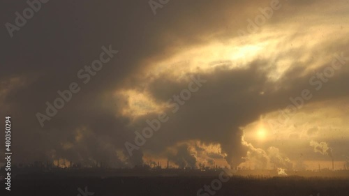 Factory chimneys pollute the air, environmental problems. It's snowing ash at sunset. Industrial pollution, exhaust fumes from the chimney. Industrial area, thick smoke. Climate change, ecology, atmos