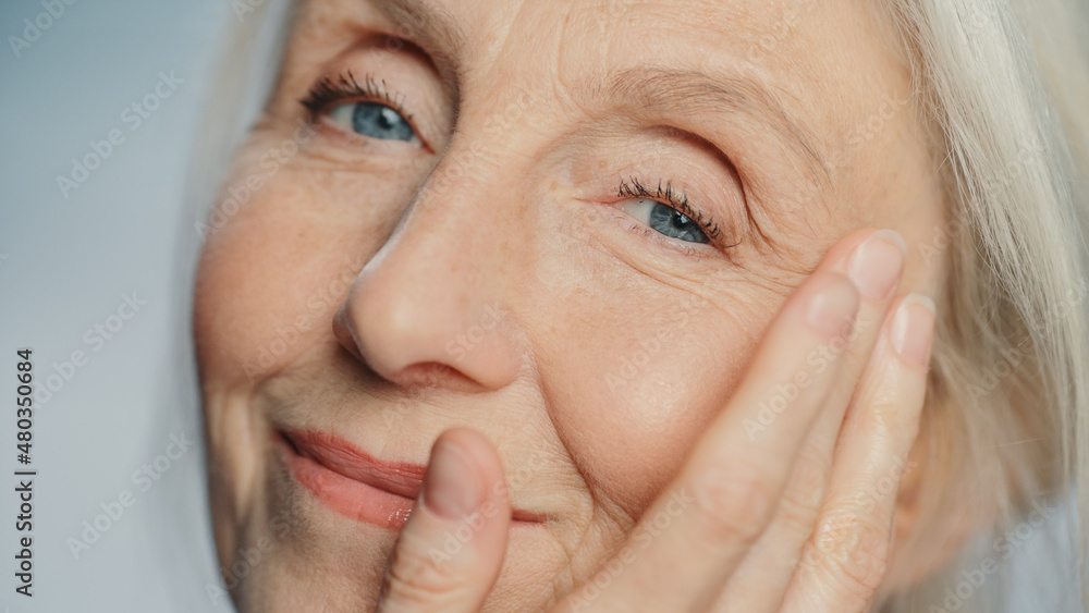 Close-up Portrait of Beautiful Senior Woman Gently Applying Face Cream. Elderly Lady Makes Her Skin Soft, Smooth, Wrinkle Free with Natural anti-aging Cosmetics. Product for Beauty Skincare Close-up Portrait of Beautiful Senior Woman Gently Applying Face Cream. Elderly Lady Makes Her Skin Soft, Smooth, Wrinkle Free with Natural anti-aging Cosmetics. Product for Beauty Skincare