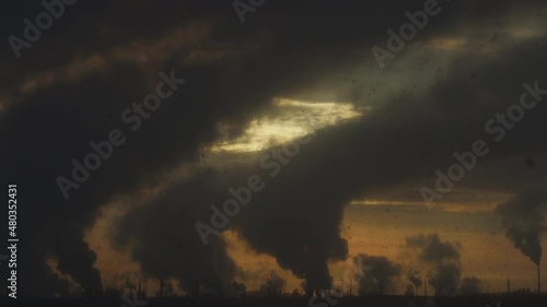 Factory chimneys pollute the air, environmental problems. It's snowing ash at sunset. Industrial pollution, exhaust fumes from the chimney. Industrial area, thick smoke. Climate change, ecology, atmos