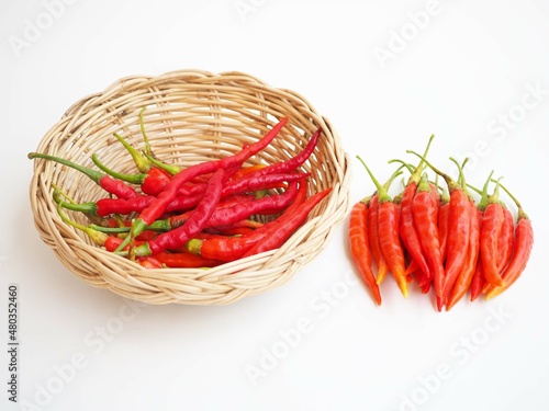 Chili pepper in wicker basket on  white background. closeup photo  blurred.