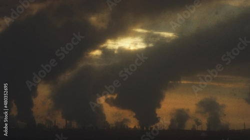 Factory chimneys pollute the air, environmental problems. It's snowing ash at sunset. Industrial pollution, exhaust fumes from the chimney. Industrial area, thick smoke. Climate change, ecology, atmos