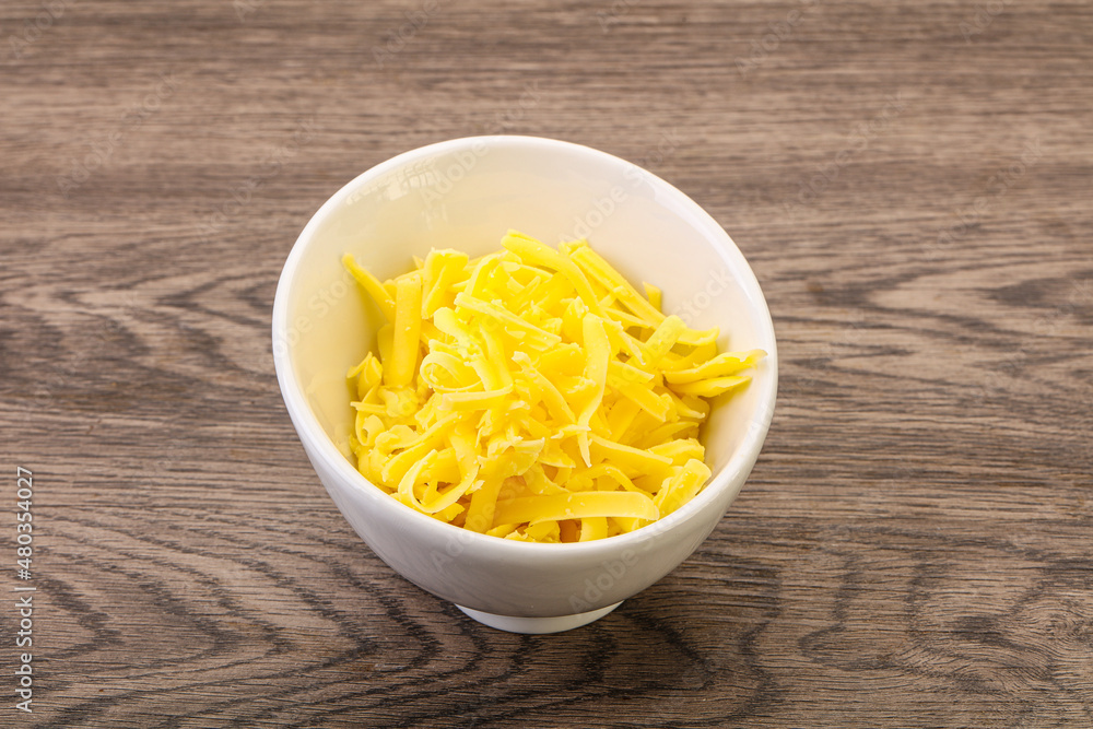 Shredded yellow cheese in the bowl Shredded yellow cheese in the bowl