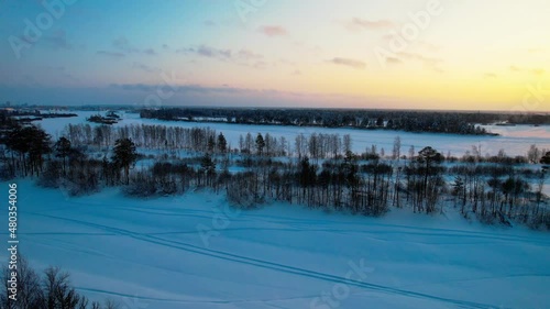 Aerial view of winter conifers forever green forest covered with snow. Snow-covered pine trees and ate on a winter day in sun weather. Aerial view.