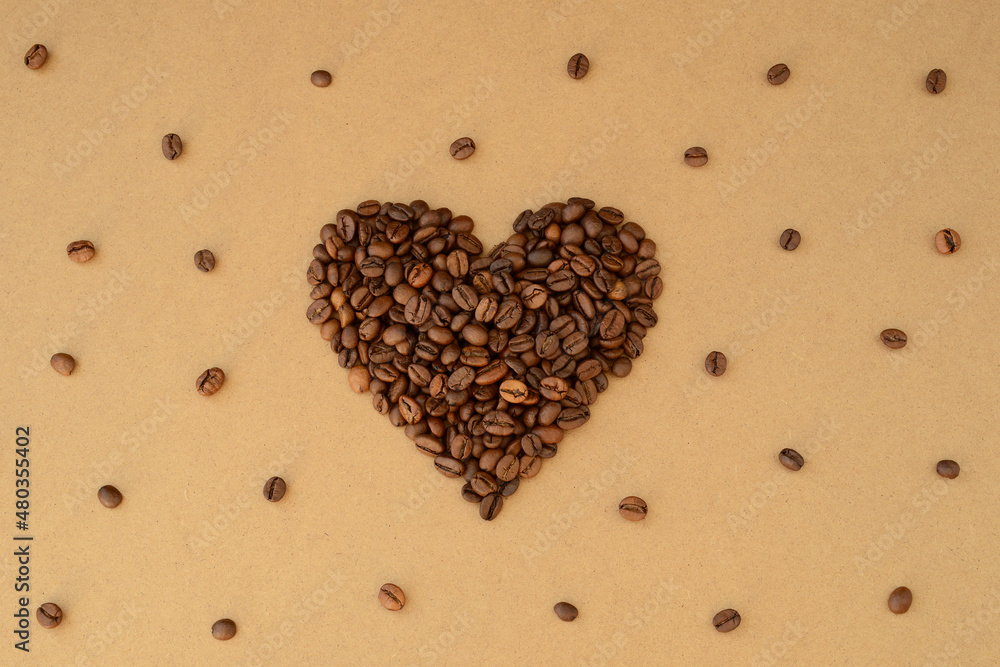 Heart shape of roasted coffee beans, pattern of coffee beans on brown paper, coffee lovers valentine