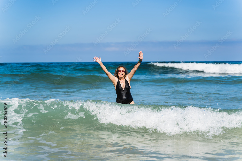 old woman on vacation on the beach.