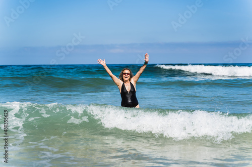 old woman on vacation on the beach.