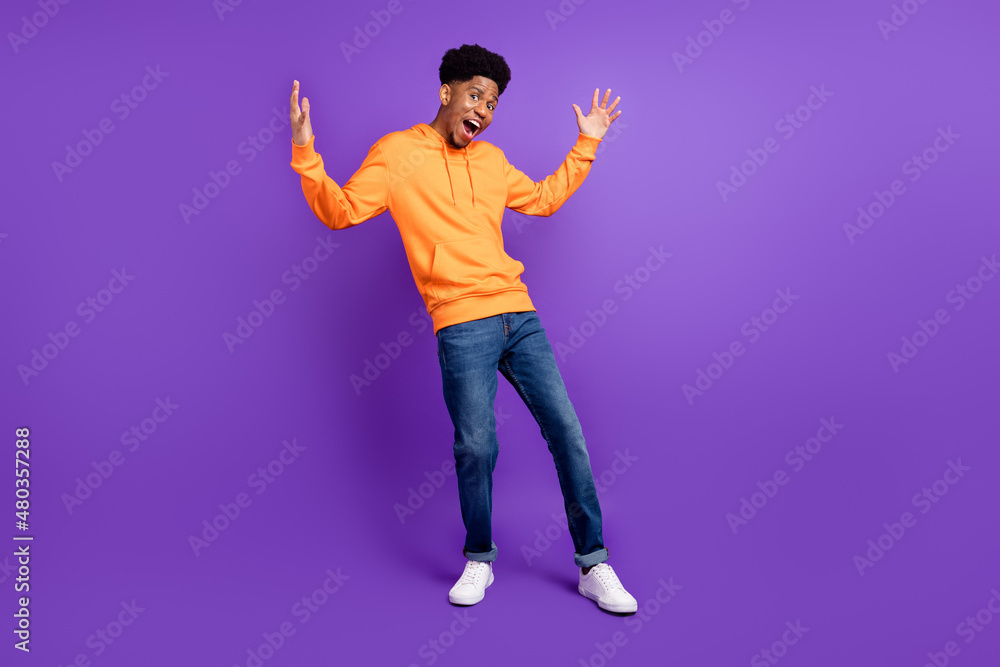 Full size photo of young afro man happy positive smile excited show hands big size measure isolated over violet color background Full size photo of young afro man happy positive smile excited show hands big size measure isolated over violet color background