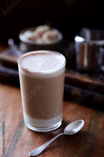 Coffee with milk on wooden background. Close up. 