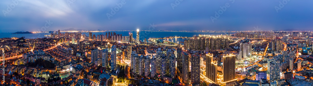Naklejka premium Aerial photography night view of modern city buildings in Qingdao, China
