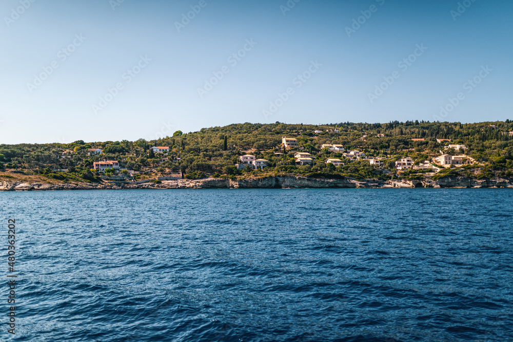 Corfu island with buildings scattered on hills at sunset