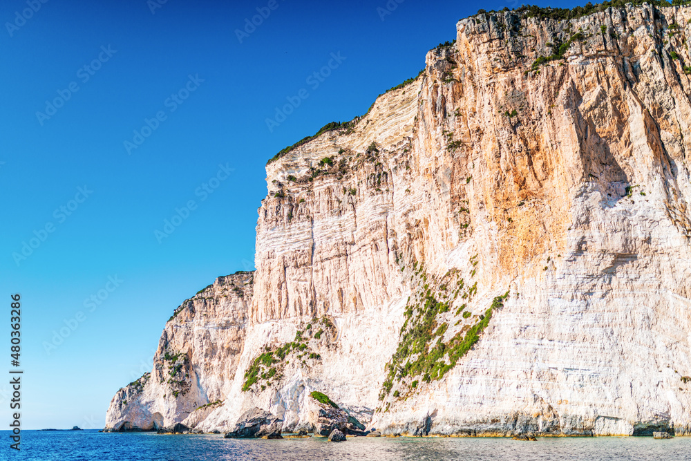 High cliffs with forest and rocks on shore of Corfu island