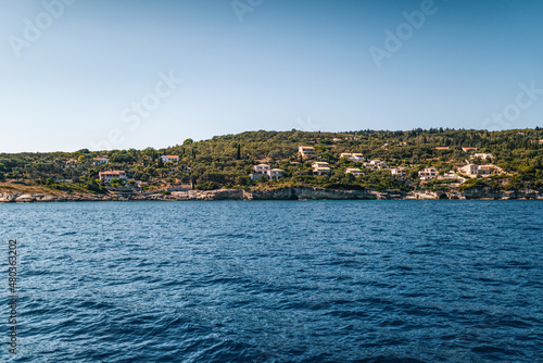 Fototapeta Naklejka Na Ścianę i Meble -  Corfu island with buildings scattered on hills at sunset