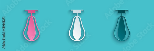 Paper cut Punching bag icon isolated on blue background. Paper art style. Vector