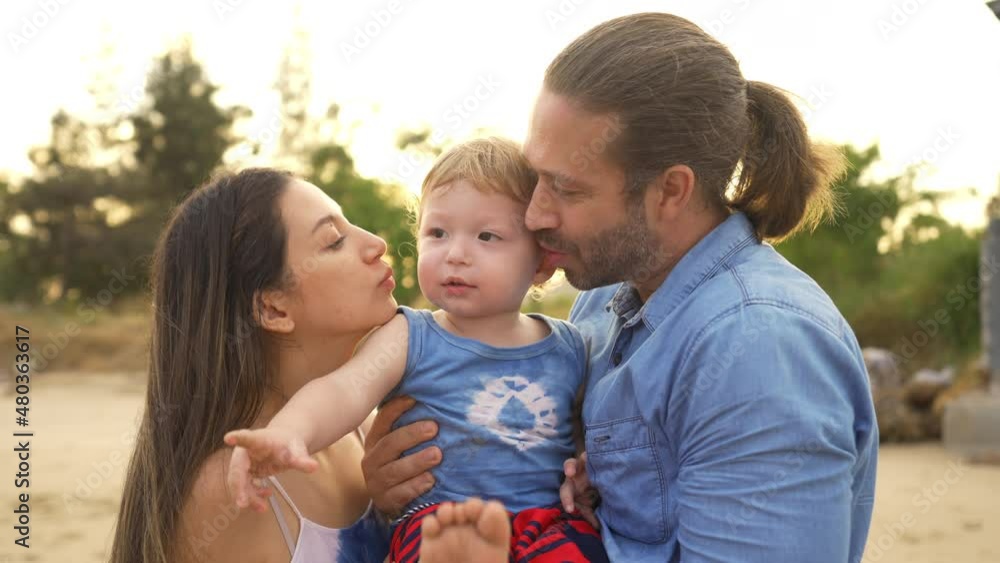Caucasian couple holding and playing with little child boy together on tropical beach. Happy family father and mother with cute baby son enjoy and fun outdoor lifestyle on summer travel beach vacation Caucasian couple holding and playing with little child boy together on tropical beach. Happy family father and mother with cute baby son enjoy and fun outdoor lifestyle on summer travel beach vacation